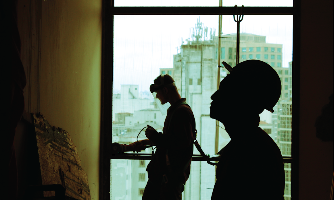 image of construction workers building an apartment block